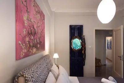 a living room with a couch and a window at Blue Ark Acropolis Light in Athens