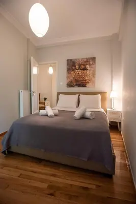 a bedroom with a large bed with two pillows at Blue Ark Acropolis Light in Athens