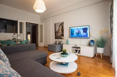 a living room with a couch and a table at Blue Ark Acropolis Light in Athens