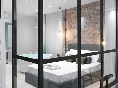a bathroom with a bed and a tub and a sink at 5 star lux suite in Kolonaki. in Athens