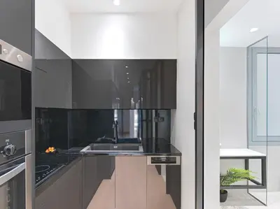 a kitchen with black counters and a sink at 5 star lux suite in Kolonaki. in Athens