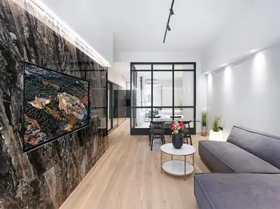 a living room with a couch and a wall at 5 star lux suite in Kolonaki. in Athens