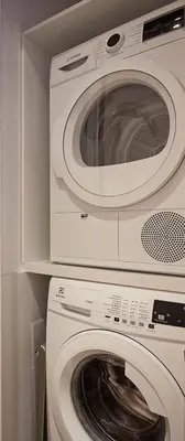 a microwave and a washing machine in a kitchen at 5 star lux suite in Kolonaki. in Athens