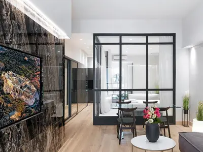 a living room with a vase of flowers on a table at 5 star lux suite in Kolonaki. in Athens