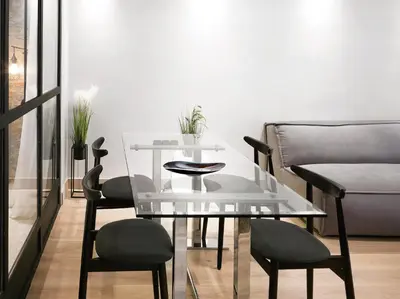 a glass table and chairs in a living room at 5 star lux suite in Kolonaki. in Athens