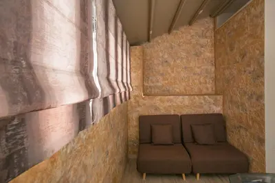 a couch in a room with a brick wall at Cosy Penthouse With Terrace Near Metro Station in Athens