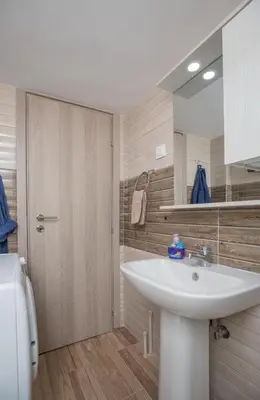 a bathroom with a white sink and a mirror at Cosy Penthouse With Terrace Near Metro Station in Athens