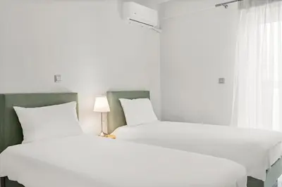 two beds sitting next to each other in a bedroom at BillyMare central Glyfada apartment in Athens