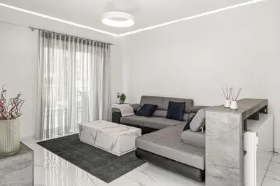 a living room with a couch and a table at BillyMare central Glyfada apartment in Athens