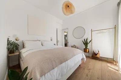 a white bedroom with a bed and a mirror at Luxurious Apartment with Big Sea View Terrace - Central Location in Athens