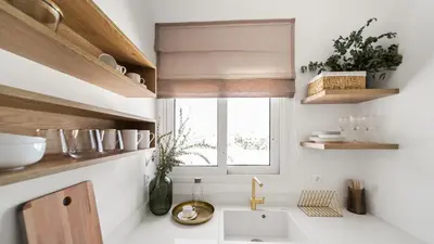 a white kitchen with a sink and a window at Luxurious Apartment with Big Sea View Terrace - Central Location in Athens