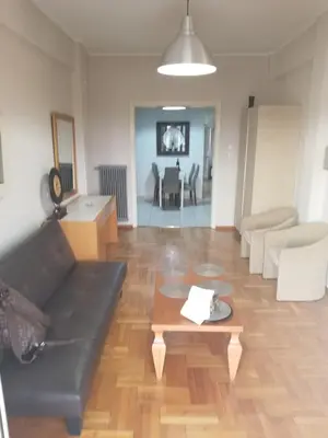 a living room with a couch and a table at ENILION ATHENS , CITY CENTER WITH VIEW TO ACROPOLIS in Athens