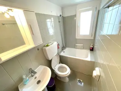 a bathroom with a white toilet and a sink at Luxury Flat in Hilton, 3' from metro, VFM! in Athens