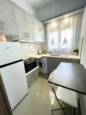a kitchen with a white refrigerator and a microwave at Luxury Flat in Hilton, 3' from metro, VFM! in Athens