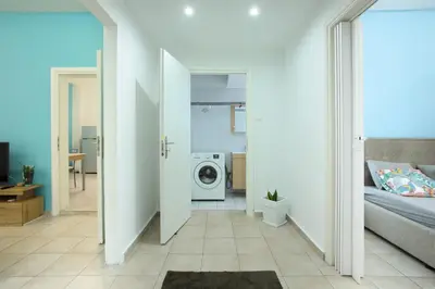 a room with a bed and a washing machine at Nikea apartment near Piraeus port and metro st I in Piraeus