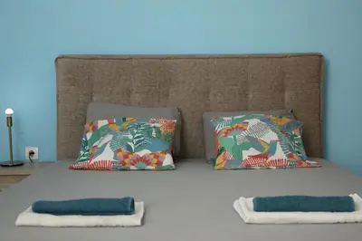 a bed with two pillows on top of it at Nikea apartment near Piraeus port and metro st I in Piraeus