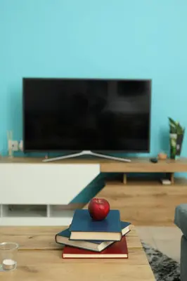 a red apple sitting on top of books on a table at Nikea apartment near Piraeus port and metro st I in Piraeus
