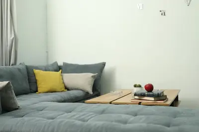 a living room with a blue couch and a coffee table at Nikea apartment near Piraeus port and metro st I in Piraeus