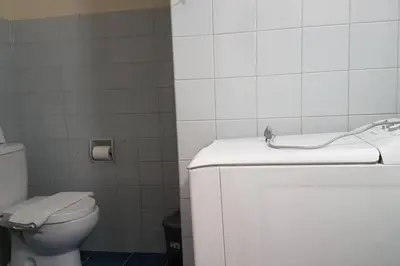 a white bathroom with a toilet and a sink at Blue Apartment - Athens Center, 4 BD, 2 BATH in Athens