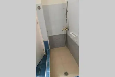 a bathroom with a shower with a tile floor at Blue Apartment - Athens Center, 4 BD, 2 BATH in Athens