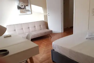 a living room with a couch and a bed at Blue Apartment - Athens Center, 4 BD, 2 BATH in Athens