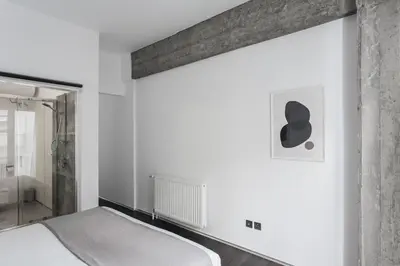 a bedroom with a bed and a mirror at Industrial 1BR Apartment in Ampelokipoi Area by UPSTREET in Athens