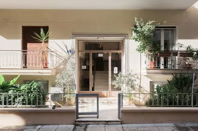 a front door of a building with plants in it at Industrial 1BR Apartment in Ampelokipoi Area by UPSTREET in Athens