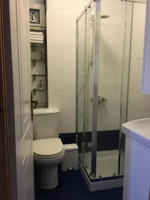 a bathroom with a toilet and a glass shower at the garden house in Dhaskalión