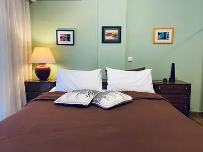 a bedroom with a bed with two pillows on it at Athens Riviera Garden Views Apartment #Unoblu in Athens