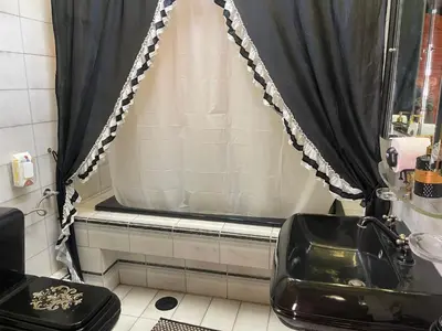 a bathroom with a sink and a shower curtain at Kouro's private room! in Piraeus