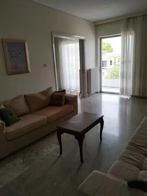 a living room with a couch and a coffee table at Vangelis apartment near Athens Airport in Spáta