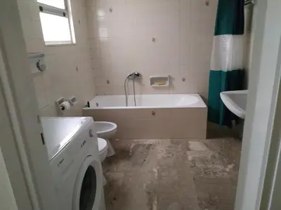 a bathroom with a tub and a toilet and a sink at Vangelis apartment near Athens Airport in Spáta