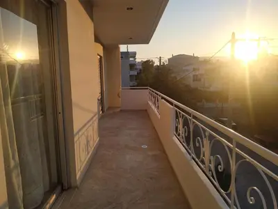 a balcony of a building with a view of a city at Vangelis apartment near Athens Airport in Spáta