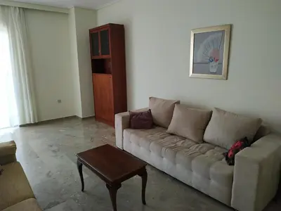 a living room with a couch and a coffee table at Vangelis apartment near Athens Airport in Spáta