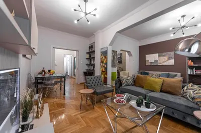 a living room with a couch and a table at Alopece City Apartment - Kolonaki in Athens