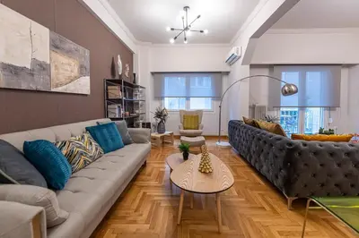 a living room with a couch and a table at Alopece City Apartment - Kolonaki in Athens