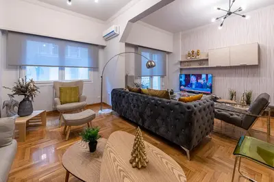 a living room with a couch and a table at Alopece City Apartment - Kolonaki in Athens