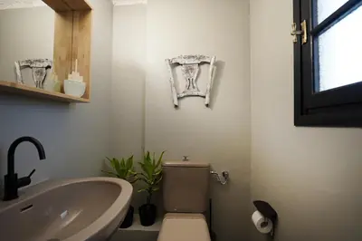 a bathroom with a sink and a toilet and a tub at Villa Xenia&Akis in Athens