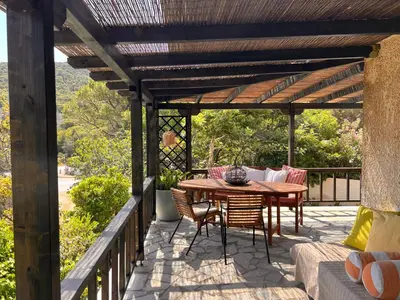 a wooden patio with a table and chairs on a deck at Villa Xenia&Akis in Athens