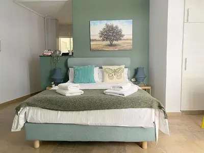 a bedroom with a blue bed with towels on it at Check Point - Museum in Athens