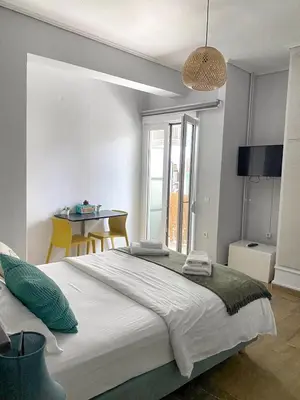 a bedroom with a large bed and a table at Check Point - Museum in Athens