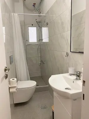 a bathroom with a toilet and a sink and a shower at Check Point - Museum in Athens