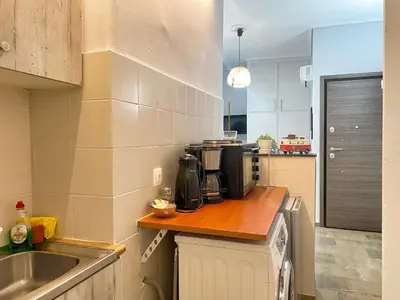 a kitchen with a counter top with a microwave at Check Point - Museum in Athens