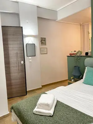 a bedroom with a bed with two towels on it at Check Point - Museum in Athens