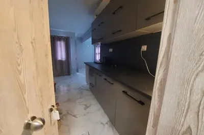 an empty kitchen with a counter top and a door at Urban Downtown Studio Back in Athens