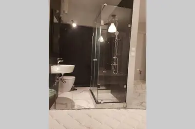 a bathroom with a shower and a toilet at Urban Downtown Studio Back in Athens