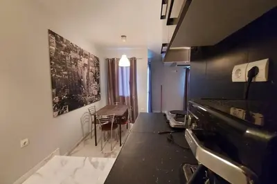 a kitchen with a black counter top and a table at Urban Downtown Studio Back in Athens
