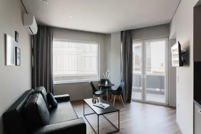 a living room with a couch and a table at WYZ Athens Apartments by UPSTREET in Athens