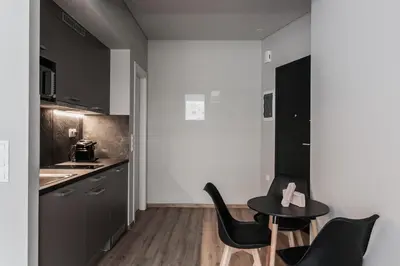 a small kitchen with a table and chairs at WYZ Athens Apartments by UPSTREET in Athens