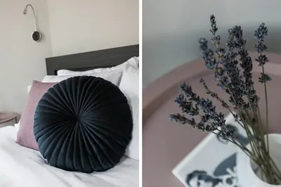 a pillow and a vase of flowers on a bed at WYZ Athens Apartments by UPSTREET in Athens